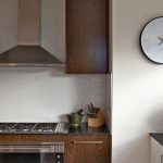 Gloss white kitchen cabinetry, retro wood veneer kitchen design